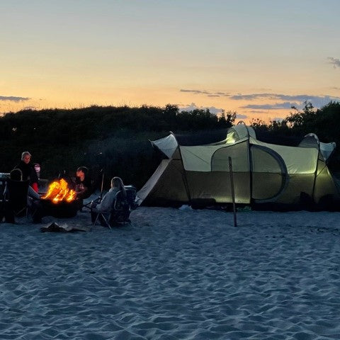 Assateague Island beach campsite with campfire and tent