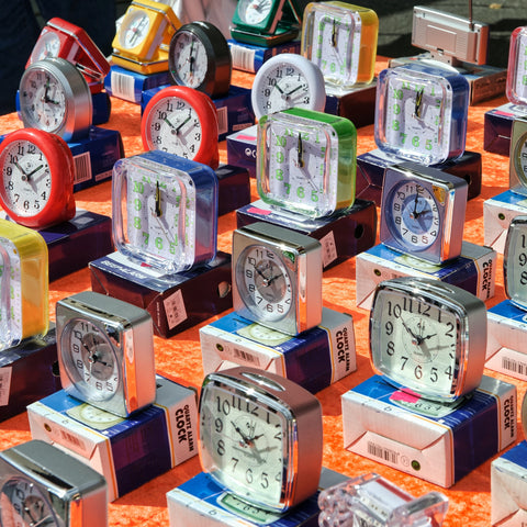Photo of colorful clocks on an orange table